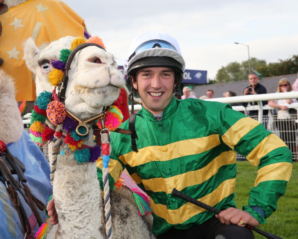 Trainer Ben Haslam is all smiles after winning the camel race