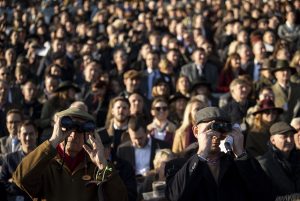 Racegoers watch the field at Cheltenham